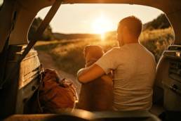 Young man enjoying financial freedom with dog