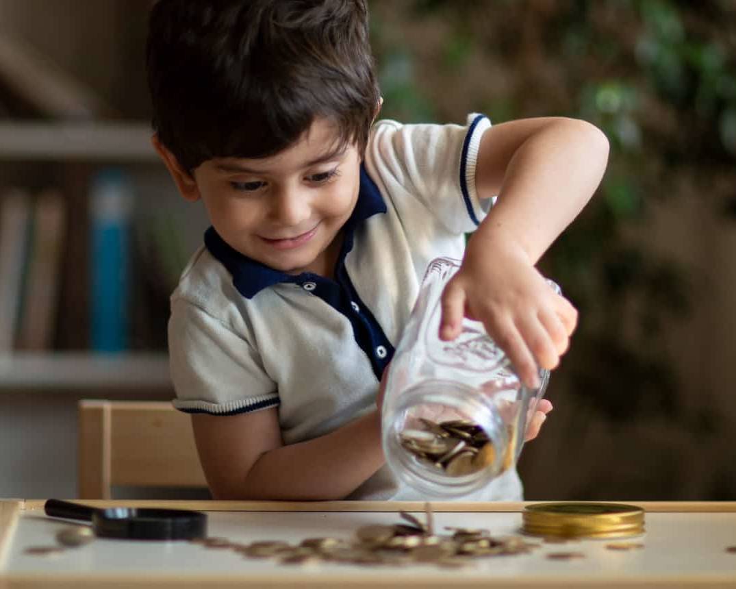 Young child starting investing and saving when young