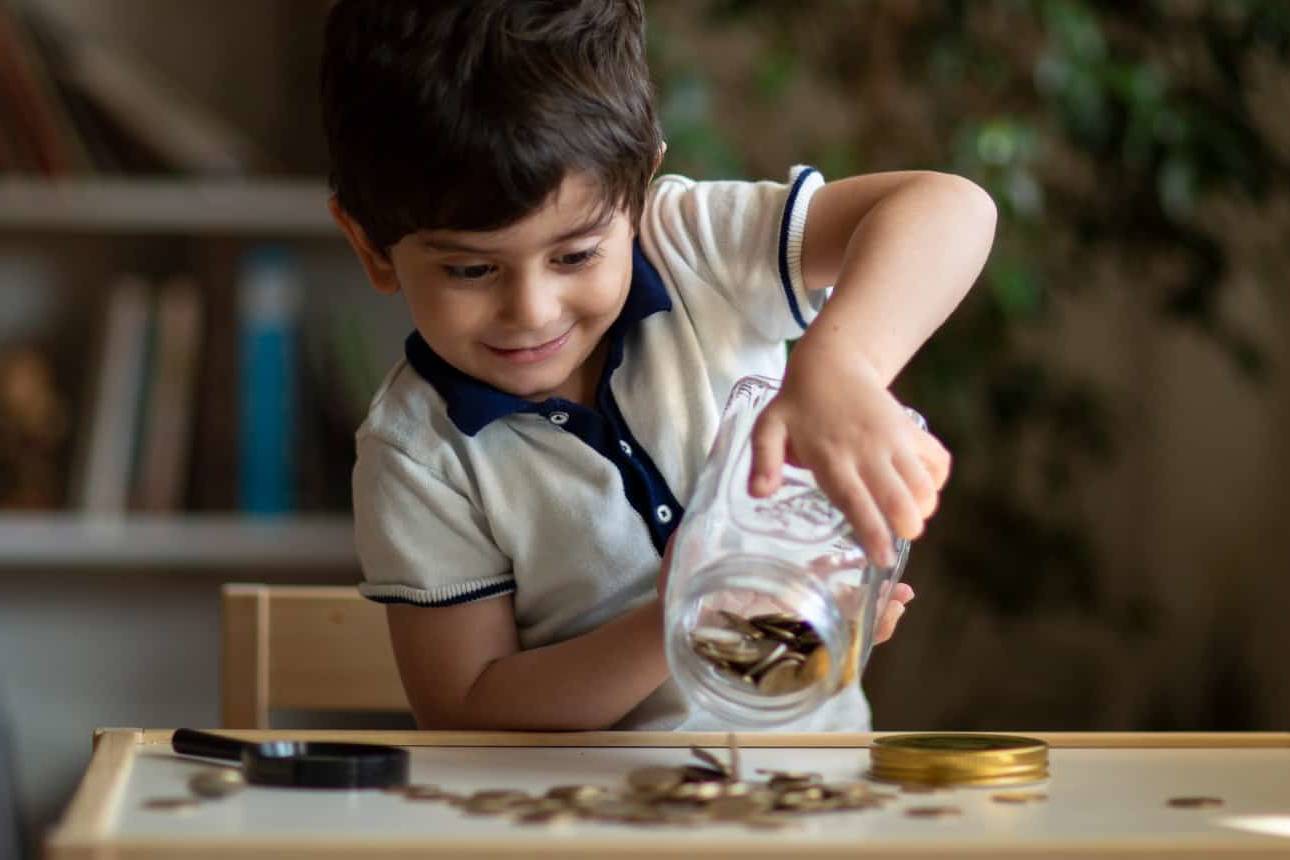 Young child starting investing and saving when young