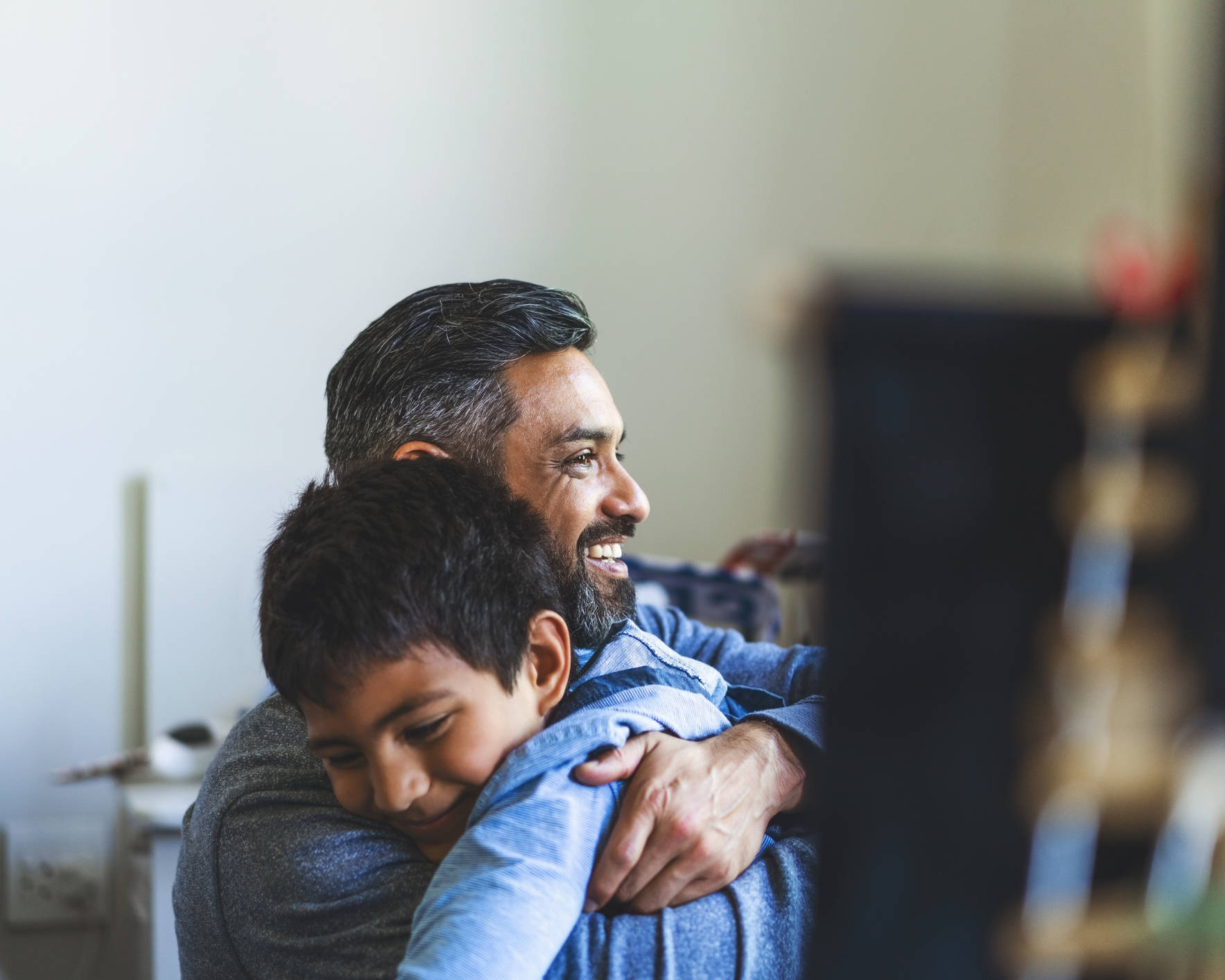 Smiling man embracing his son