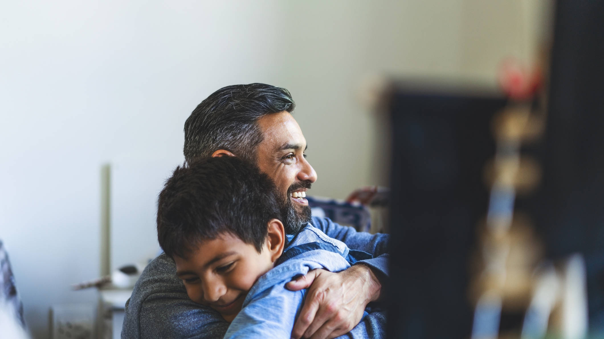 Smiling man embracing his son