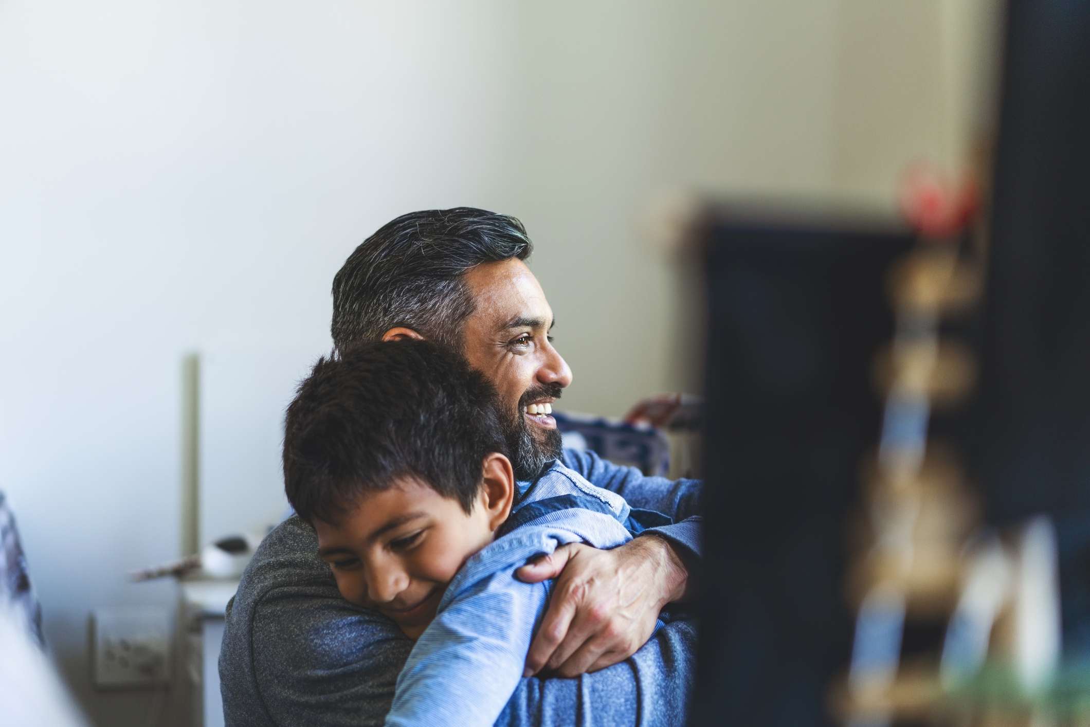 Smiling man embracing his son