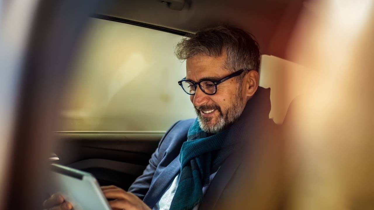 Man in car on a tablet