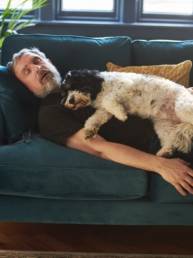 Man and dog dreaming on the sofa