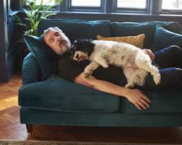Man and dog dreaming on the sofa