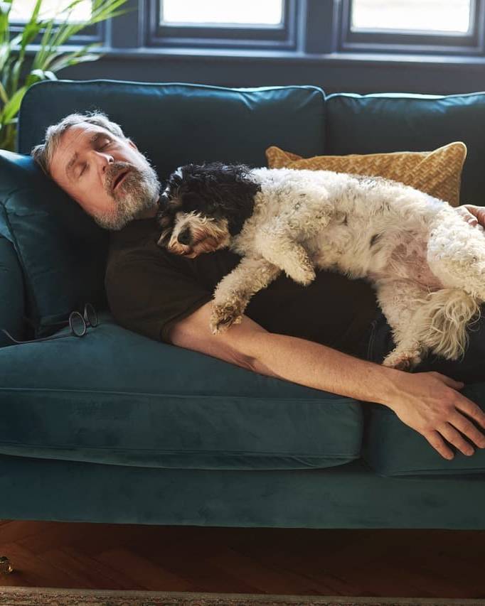 Man and dog dreaming on the sofa