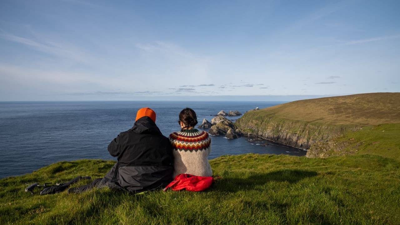 Couple sitting on cliff