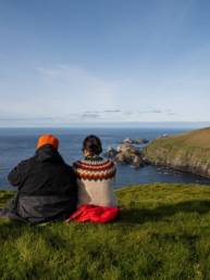 Couple sitting on cliff