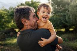 Grandfather and child laughing