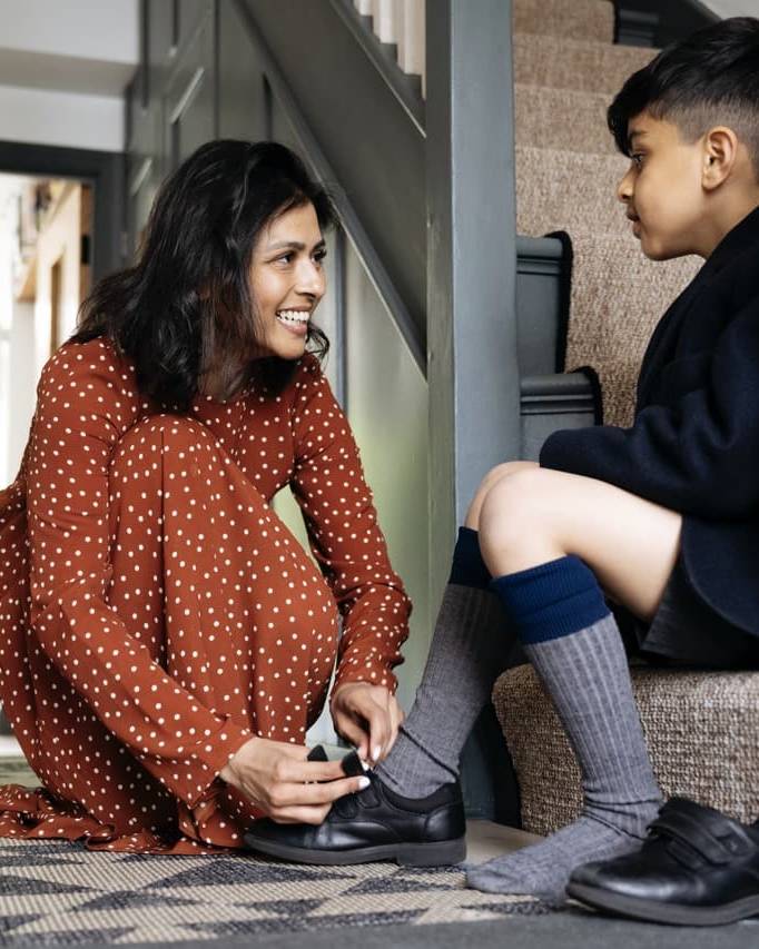Mother helping son with shoes