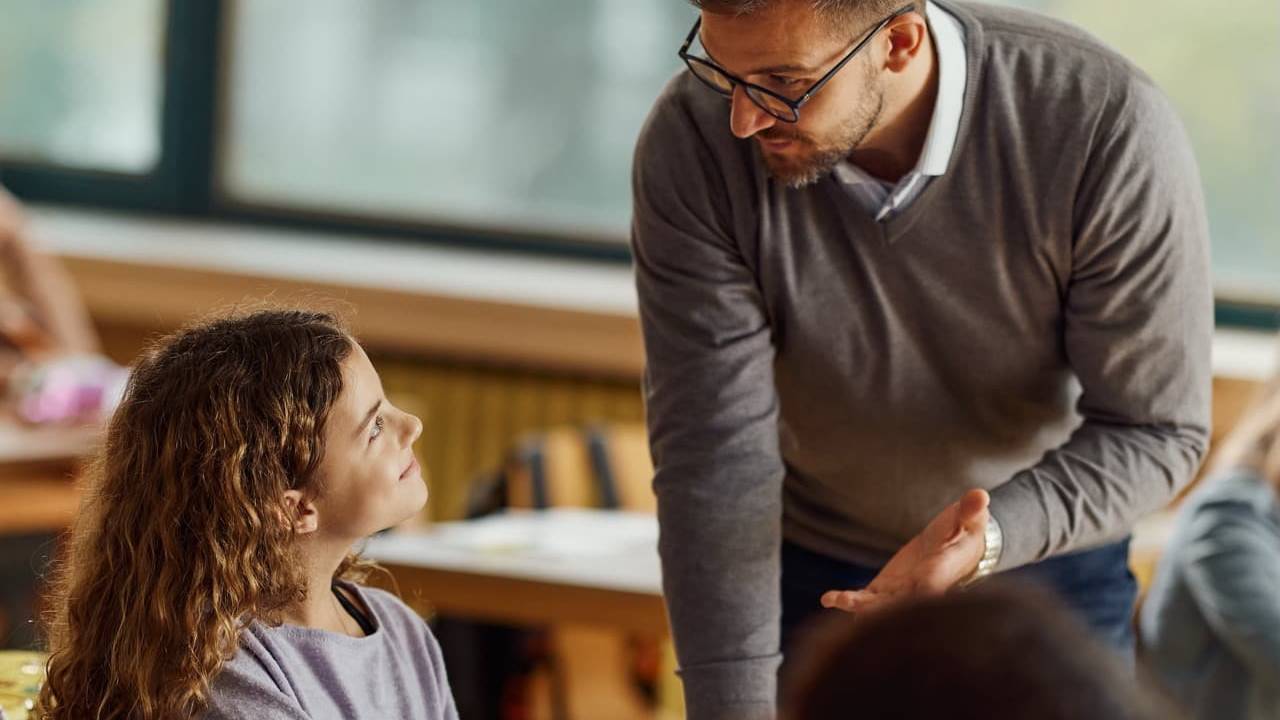 Teacher speaking to student