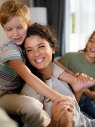 Parents and children sharing a happy moment at home, representing family financial security and long-term planning