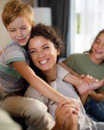 Parents and children sharing a happy moment at home, representing family financial security and long-term planning