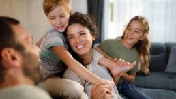 Parents and children sharing a happy moment at home, representing family financial security and long-term planning