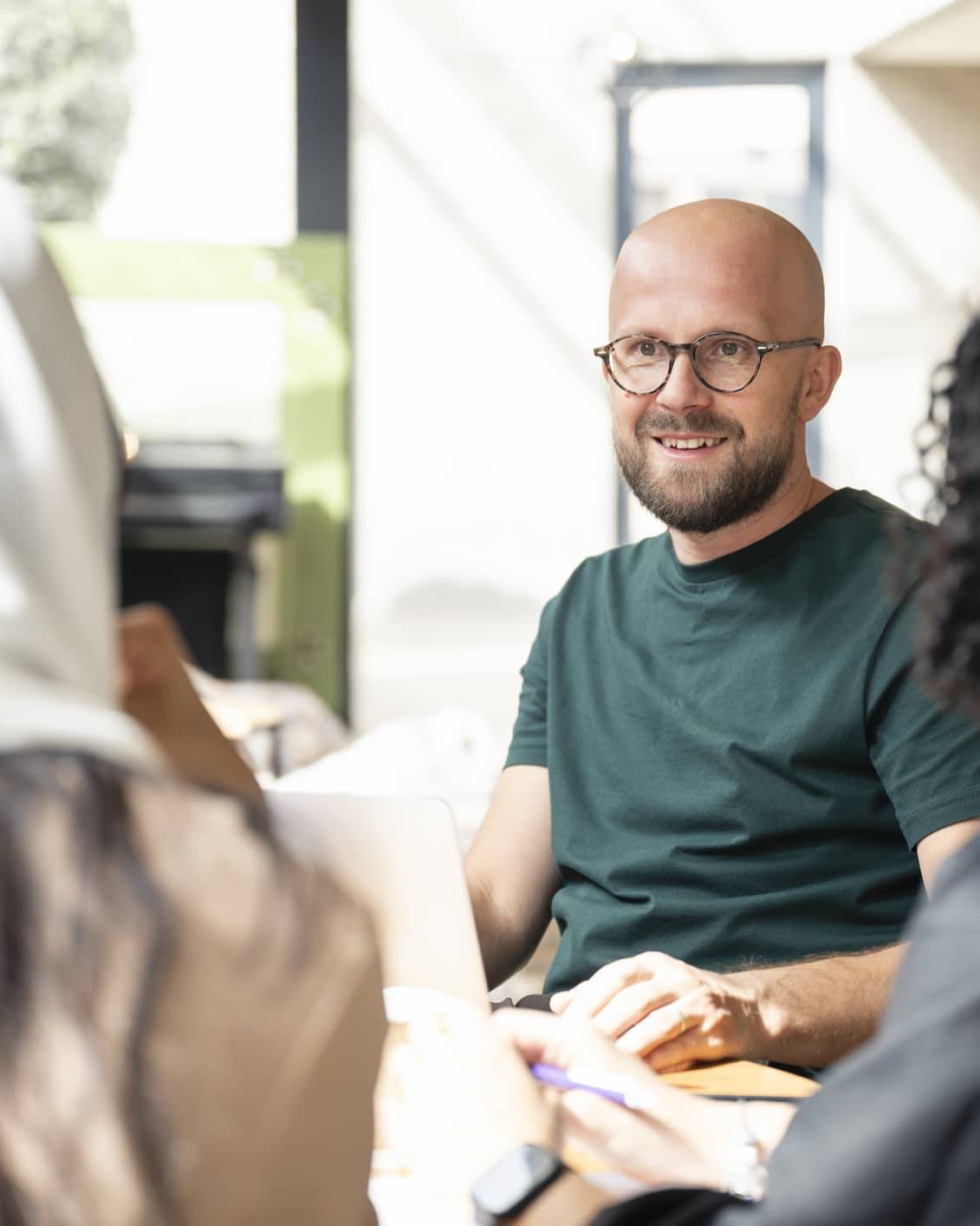 Financial planner and advisers discussing tax planning, retirement and business finances during a client meeting.