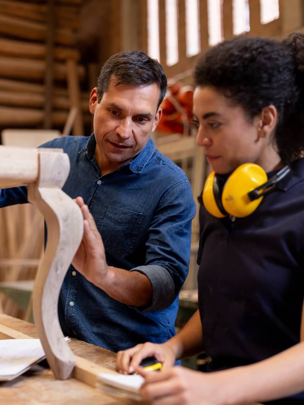 Experienced craftsperson guiding an apprentice while transitioning into retirement through a mentoring role.