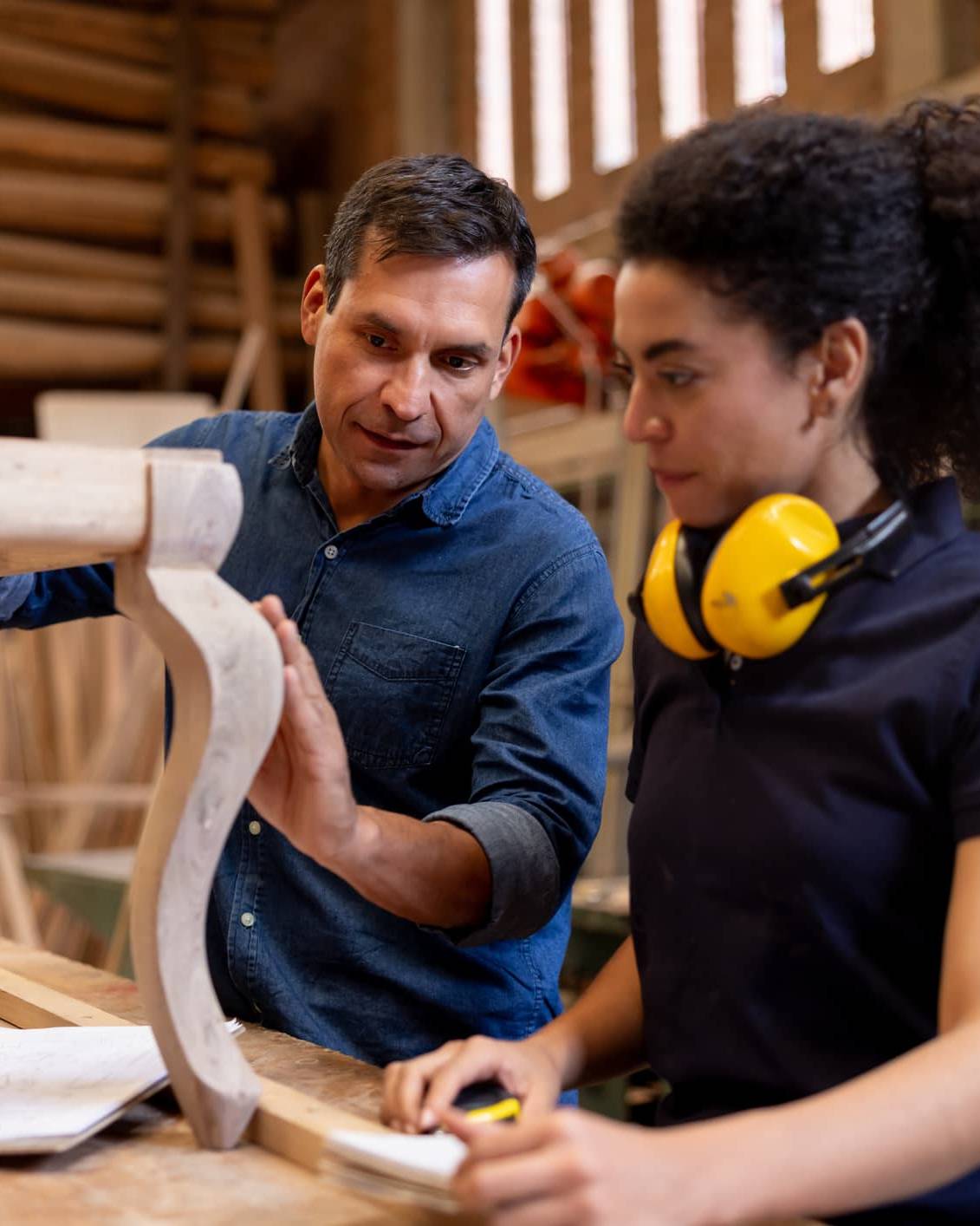 Experienced craftsperson guiding an apprentice while transitioning into retirement through a mentoring role.