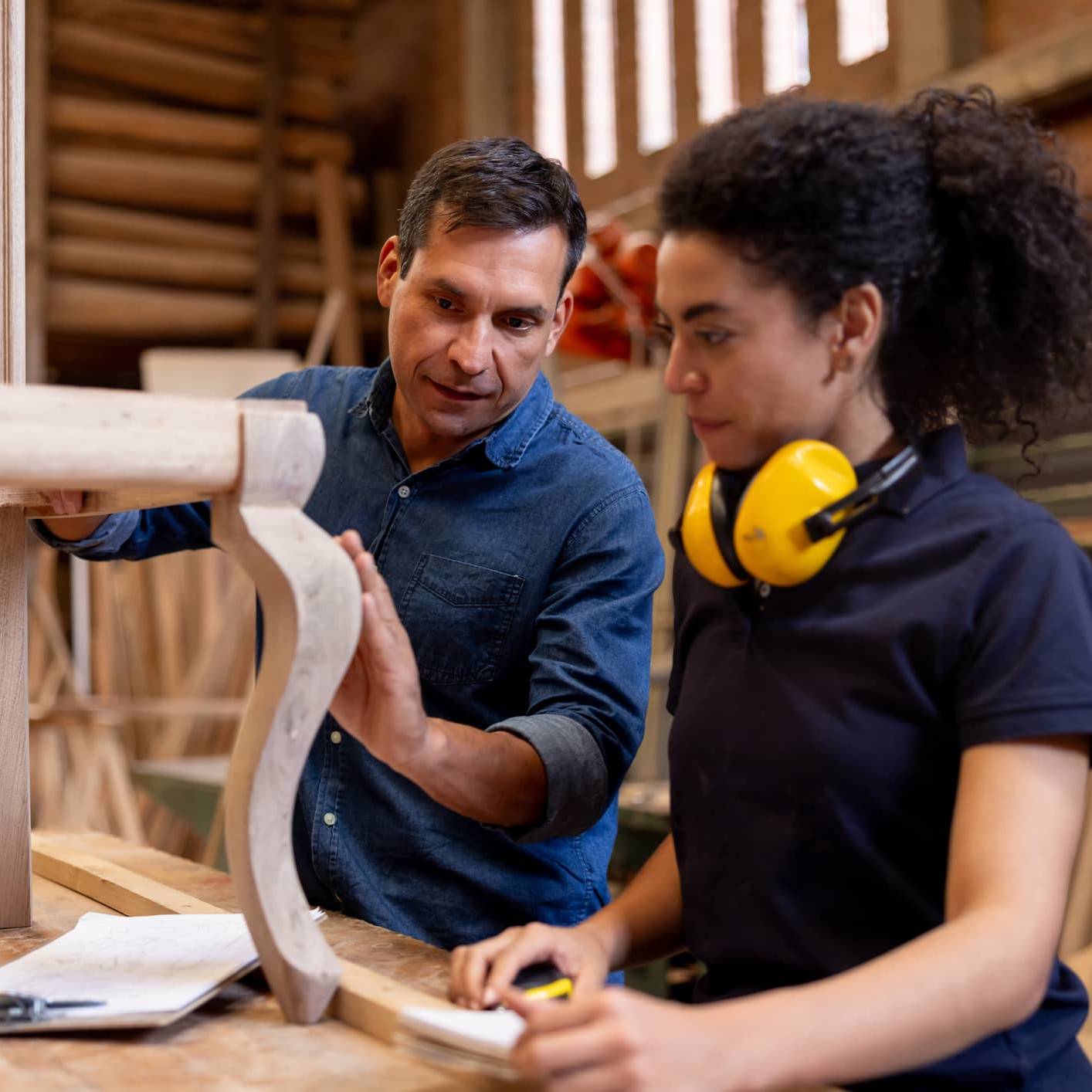 Experienced craftsperson guiding an apprentice while transitioning into retirement through a mentoring role.