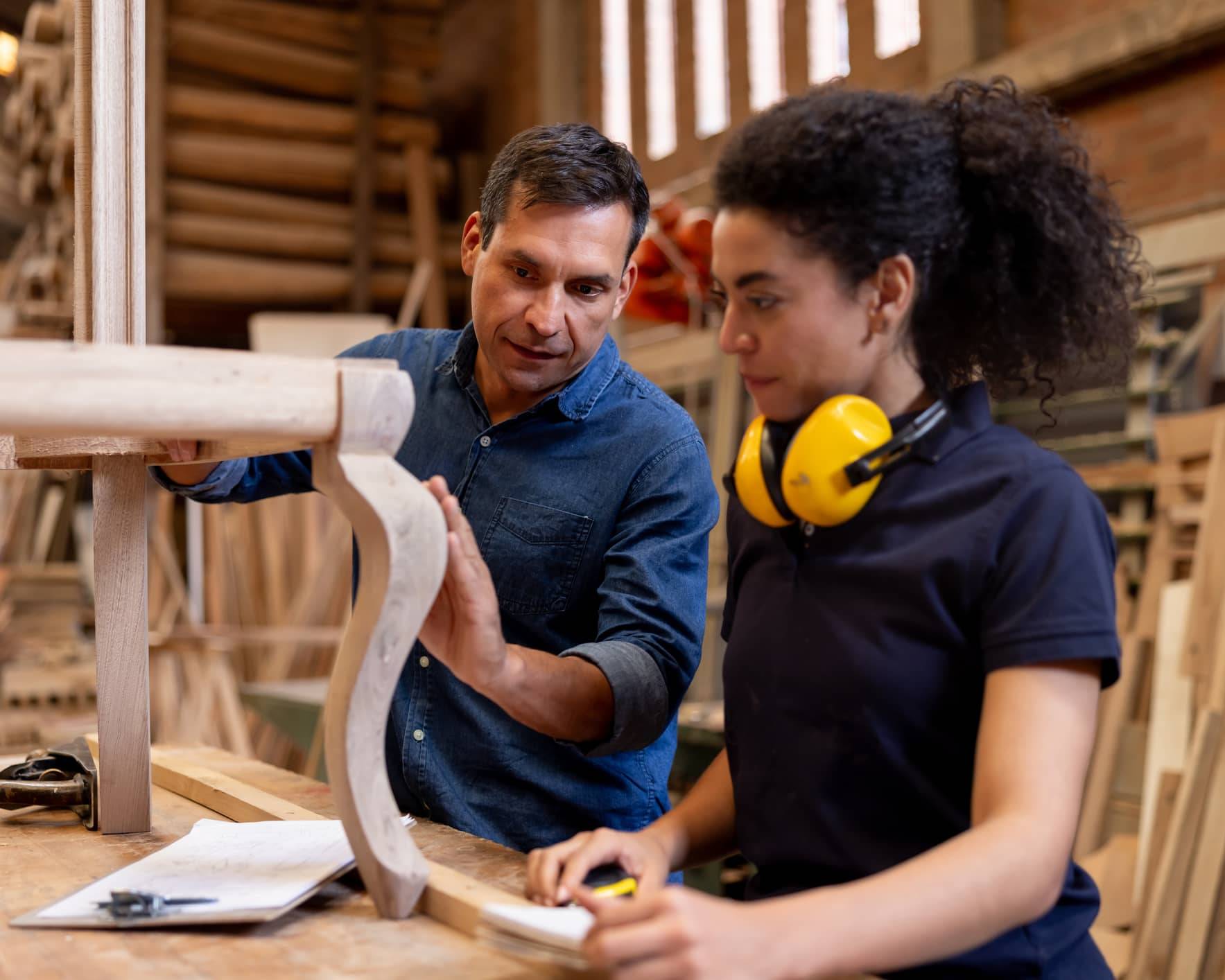 Experienced craftsperson guiding an apprentice while transitioning into retirement through a mentoring role.