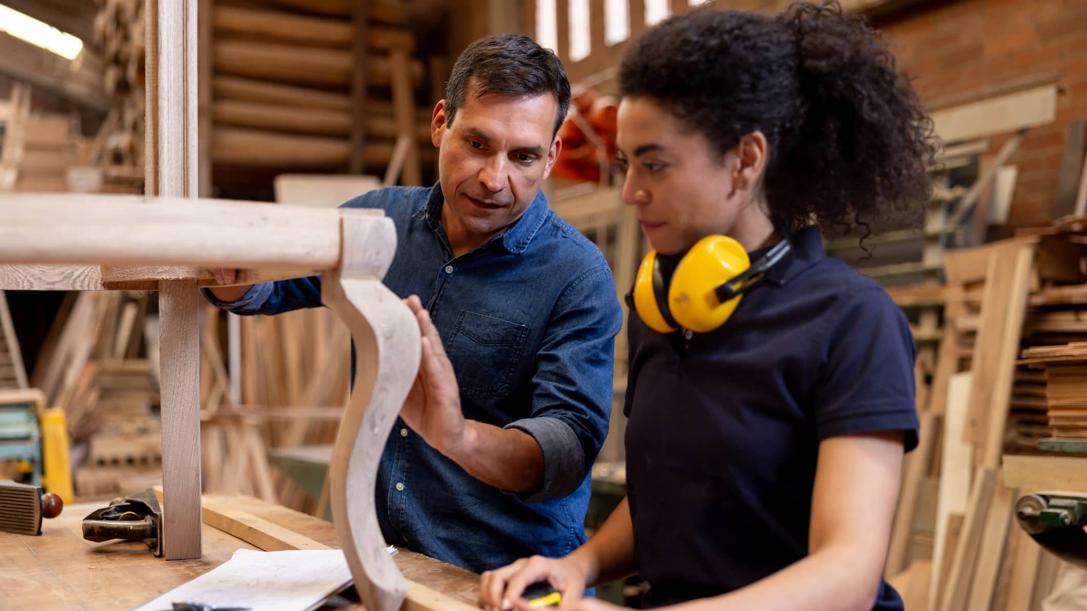 Experienced craftsperson guiding an apprentice while transitioning into retirement through a mentoring role.