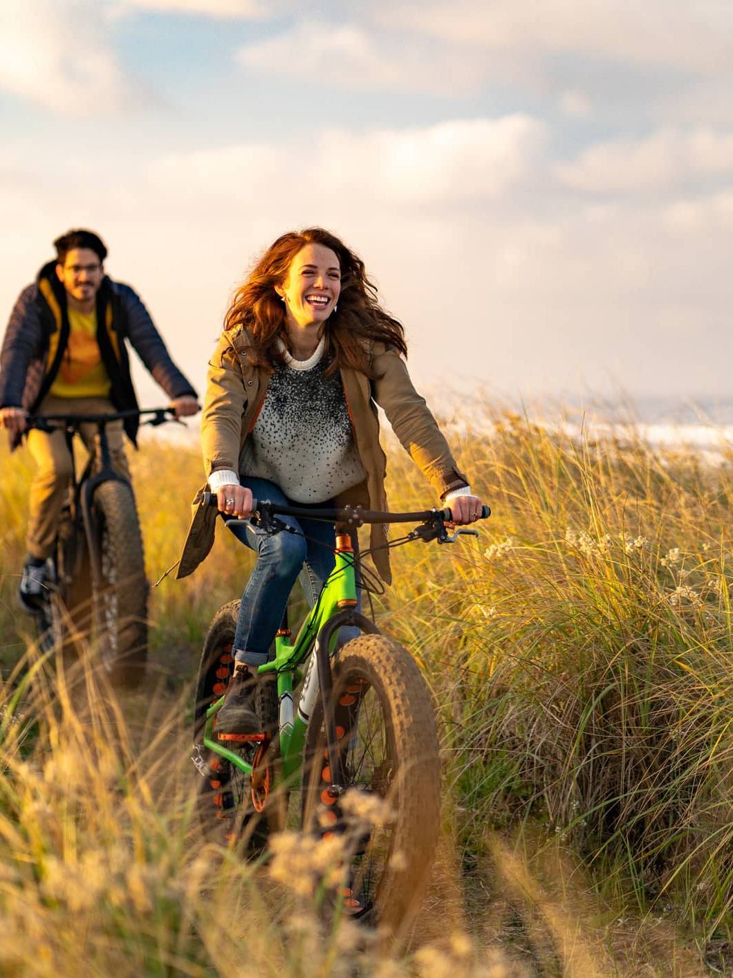 Couple cycling along a coastal path, illustrating long-term pension planning after the proposed Inheritance Tax changes.
