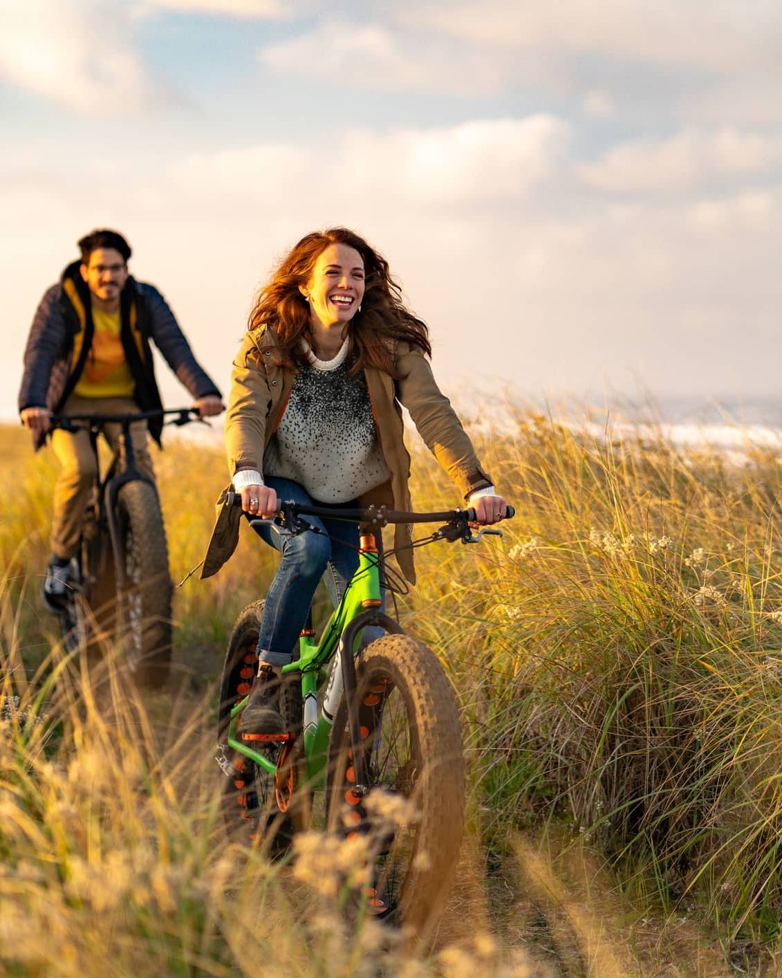 Couple cycling along a coastal path, illustrating long-term pension planning after the proposed Inheritance Tax changes.