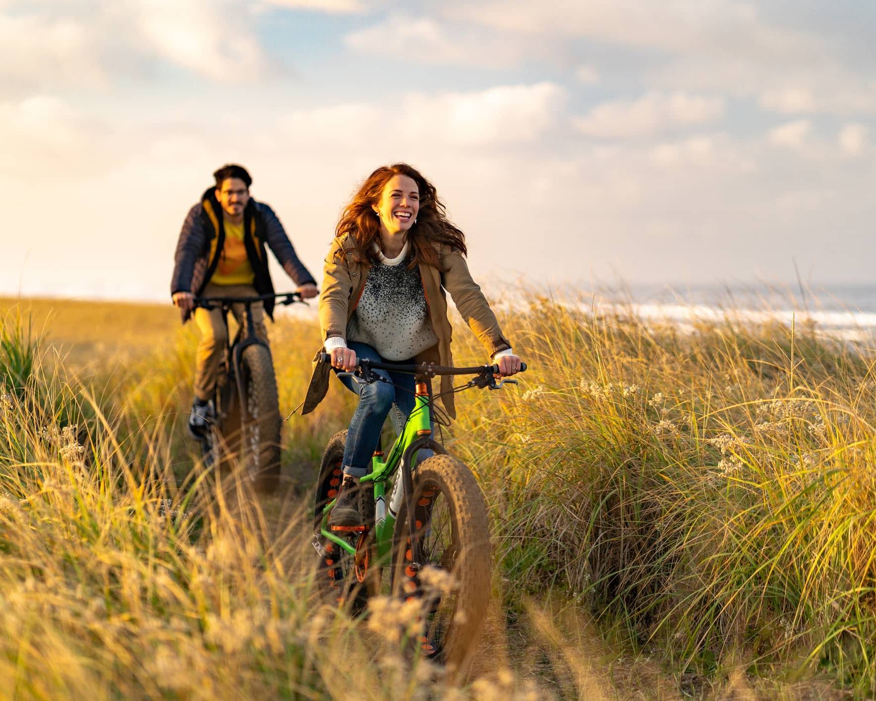 Couple cycling along a coastal path, illustrating long-term pension planning after the proposed Inheritance Tax changes.