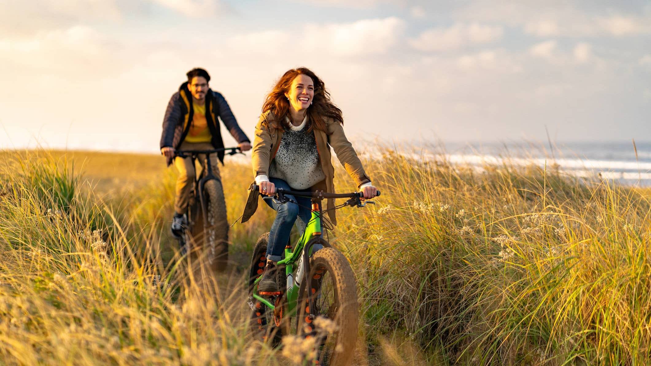 Couple cycling along a coastal path, illustrating long-term pension planning after the proposed Inheritance Tax changes.