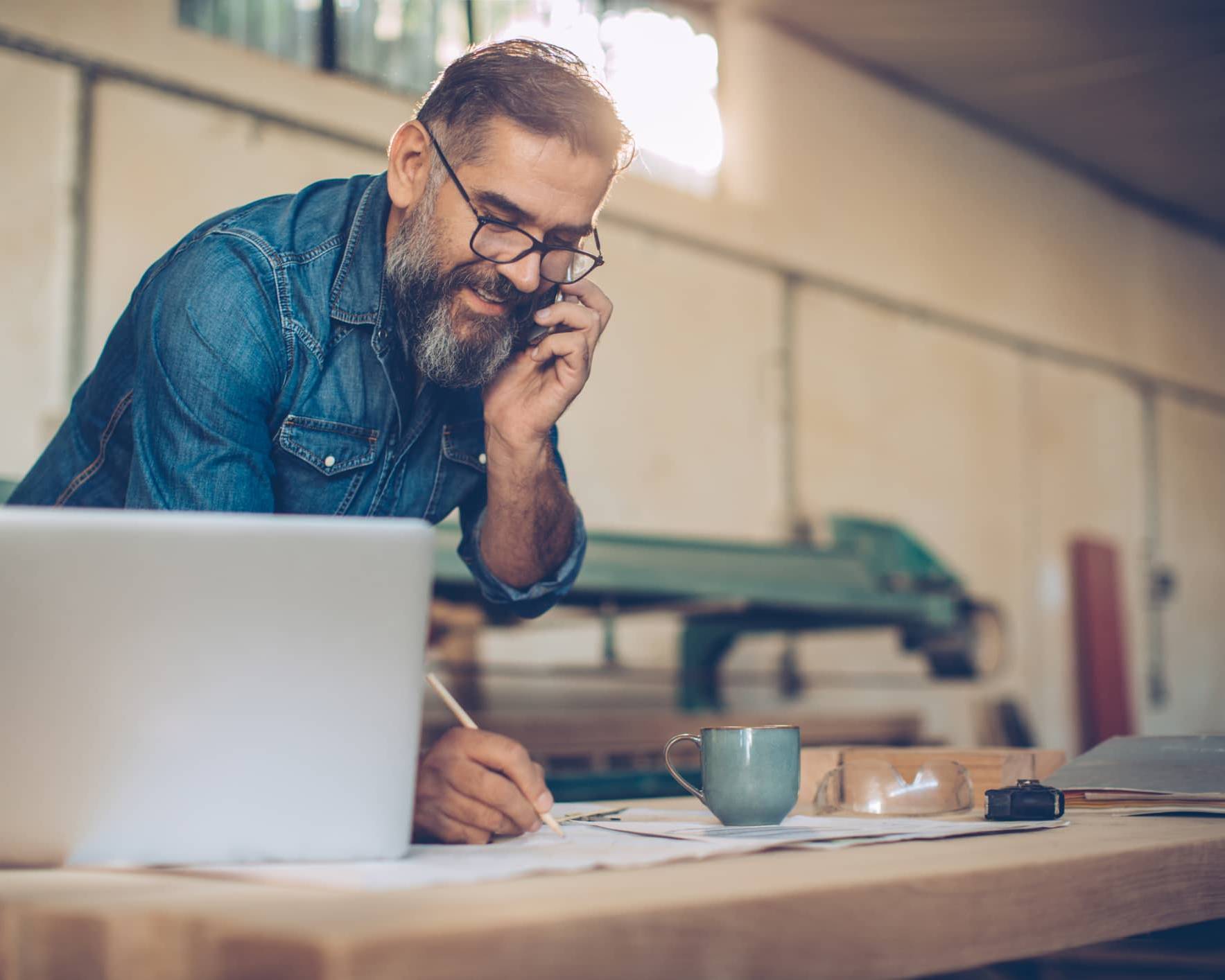 Business owner speaking on the phone while planning investments and long-term personal wealth outside the business