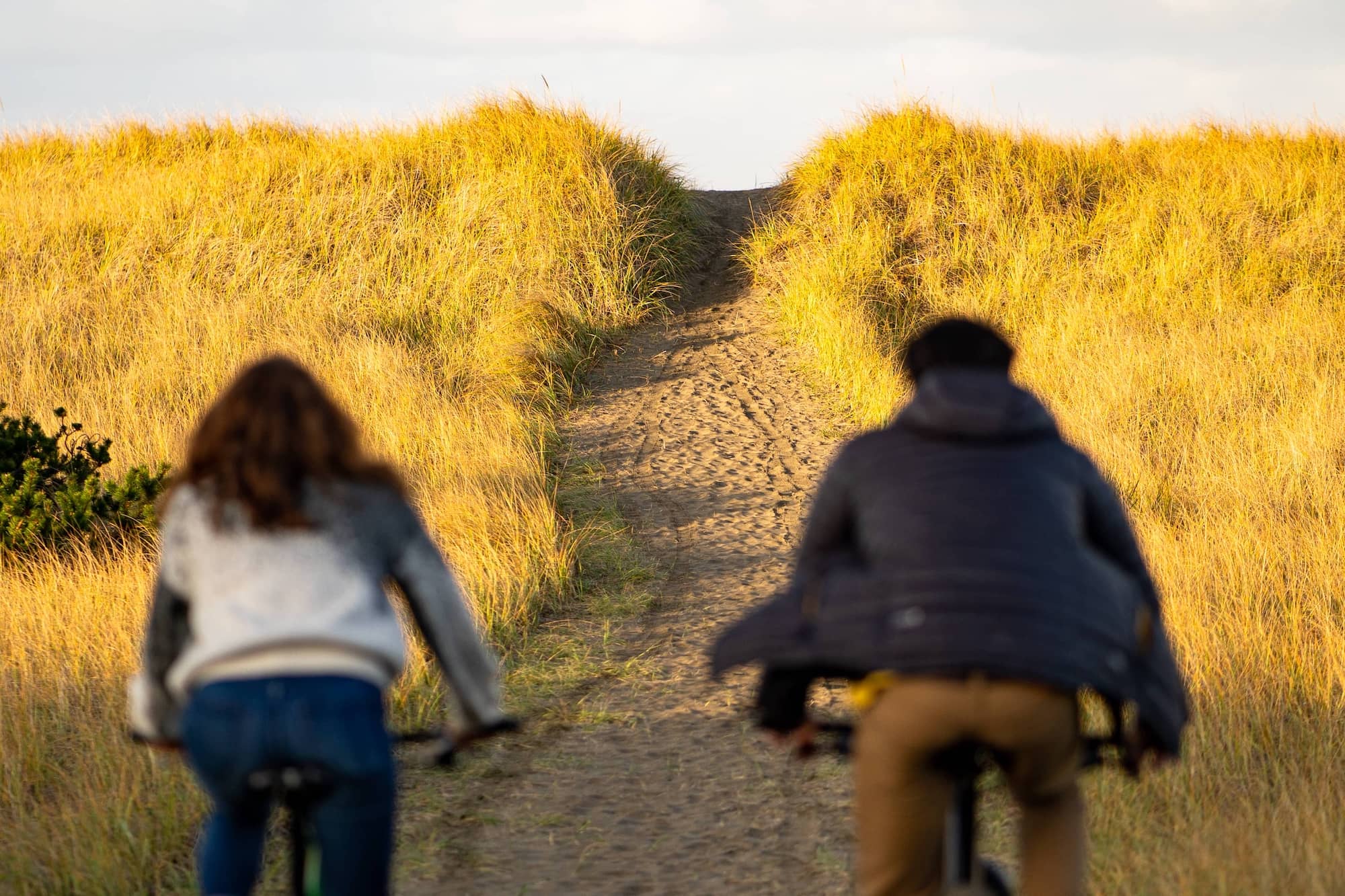 Couple cycling towards the future, representing retirement planning, pension savings and long-term financial goals.