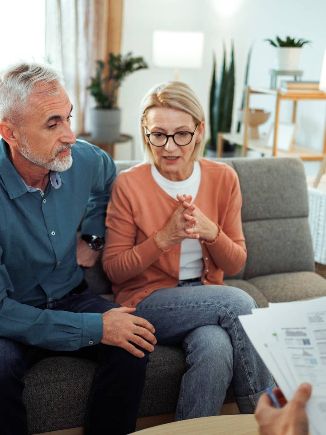 Couple discussing their financial plans with a financial adviser