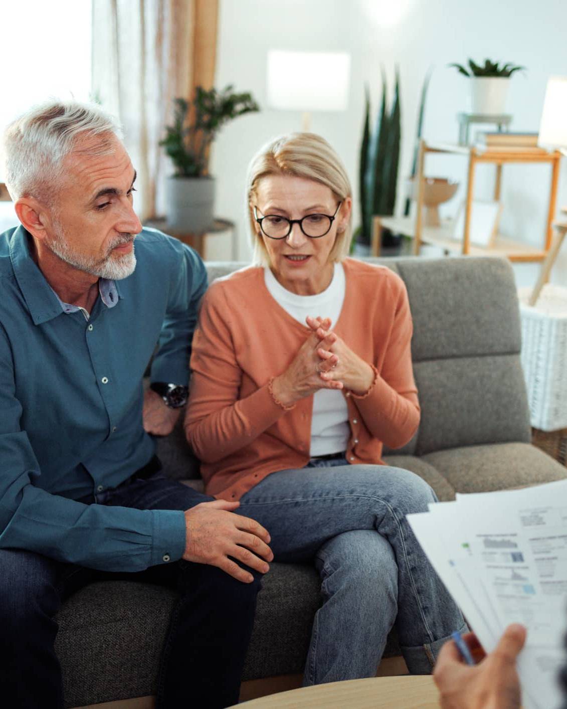 Couple discussing their financial plans with a financial adviser