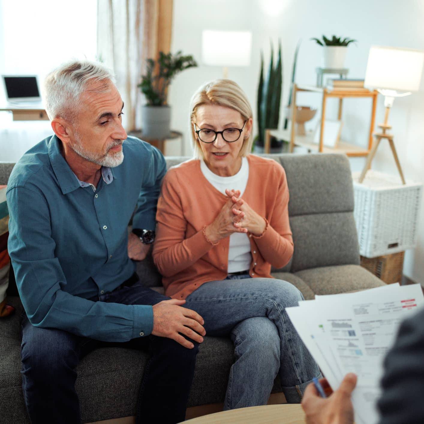 Couple discussing their financial plans with a financial adviser