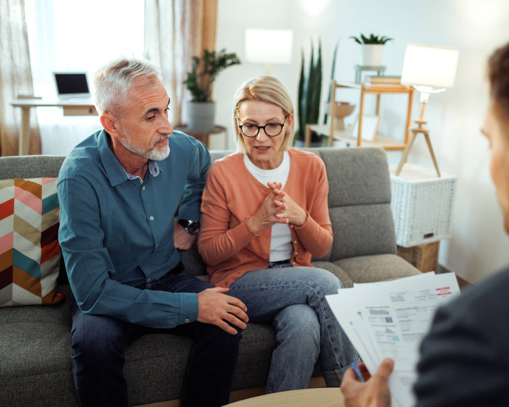 Couple discussing their financial plans with a financial adviser