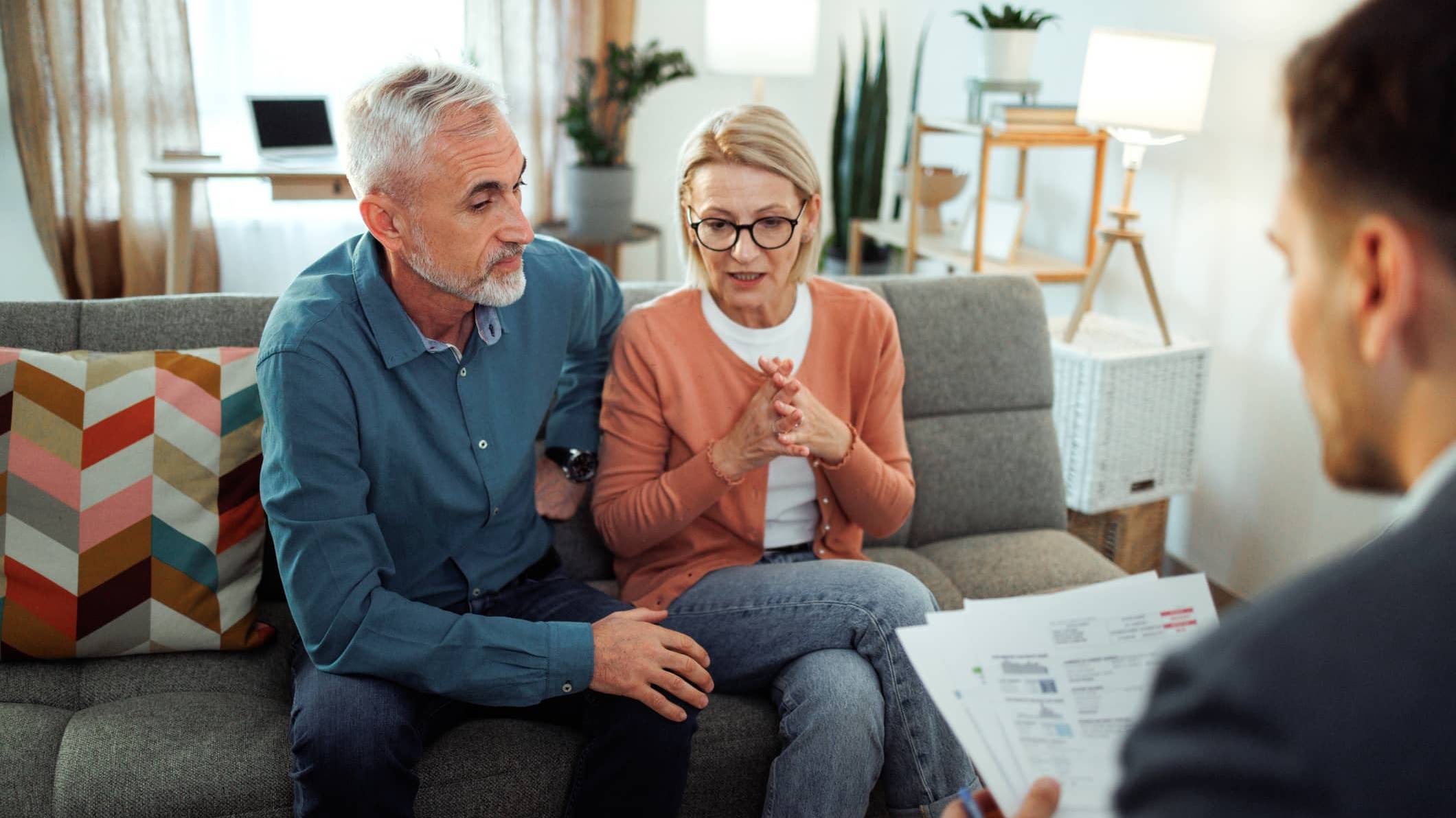 Couple discussing their financial plans with a financial adviser