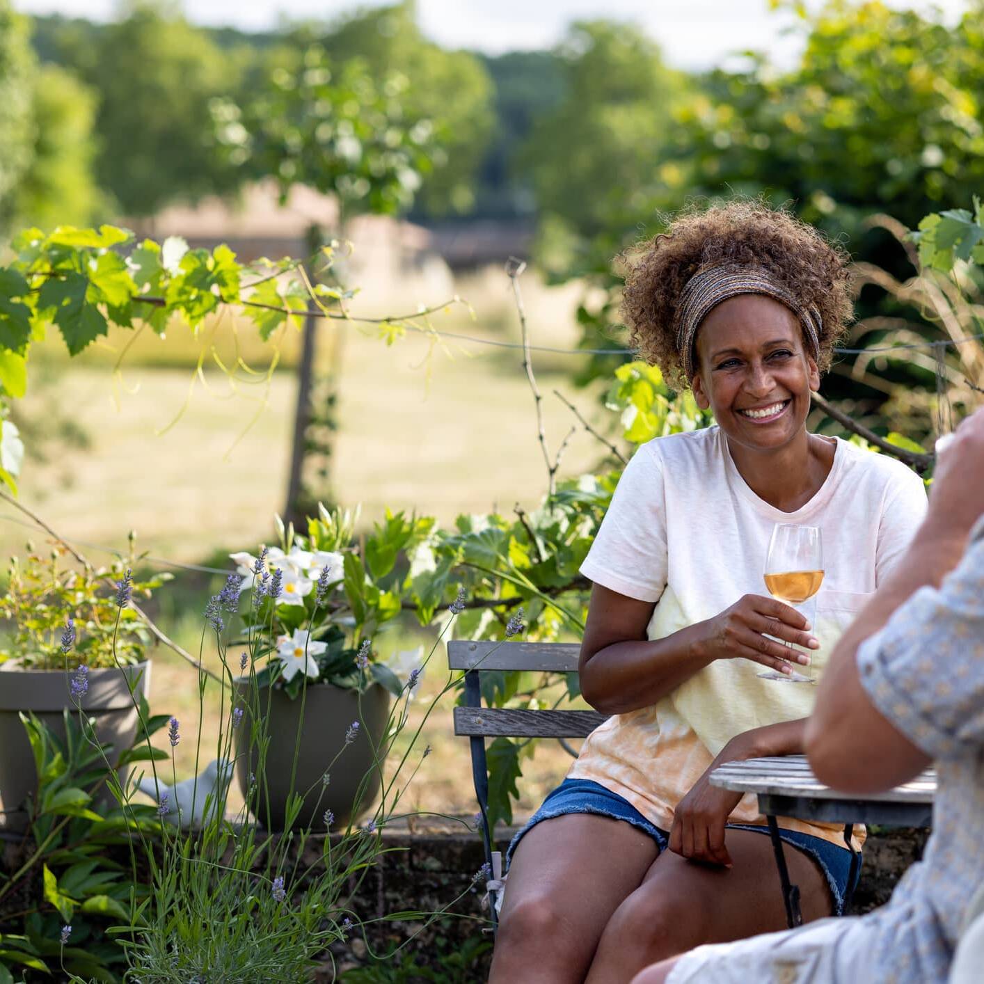 Couple relaxing outdoors with a glass of wine in retirement