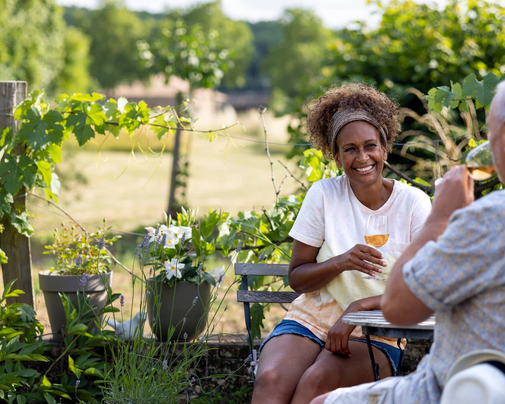 Couple relaxing outdoors with a glass of wine in retirement