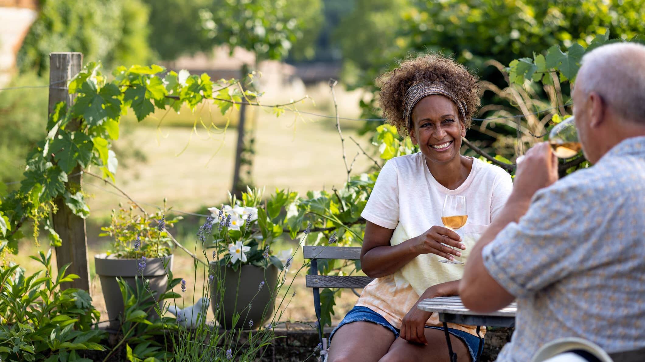 Couple relaxing outdoors with a glass of wine in retirement