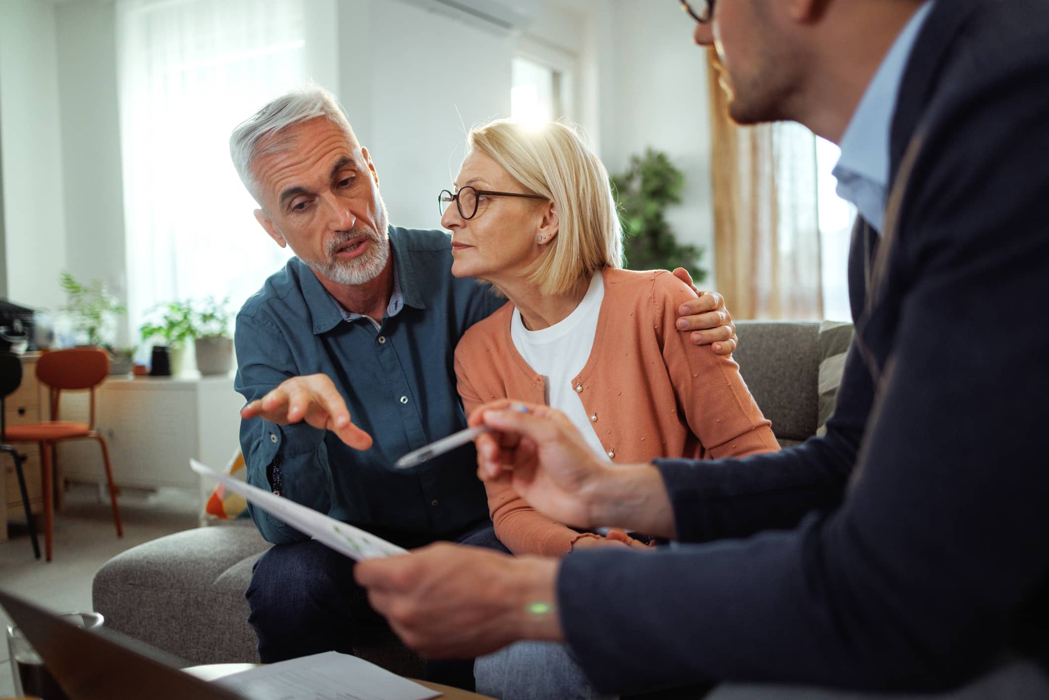 Couple reviewing retirement plans with a financial adviser