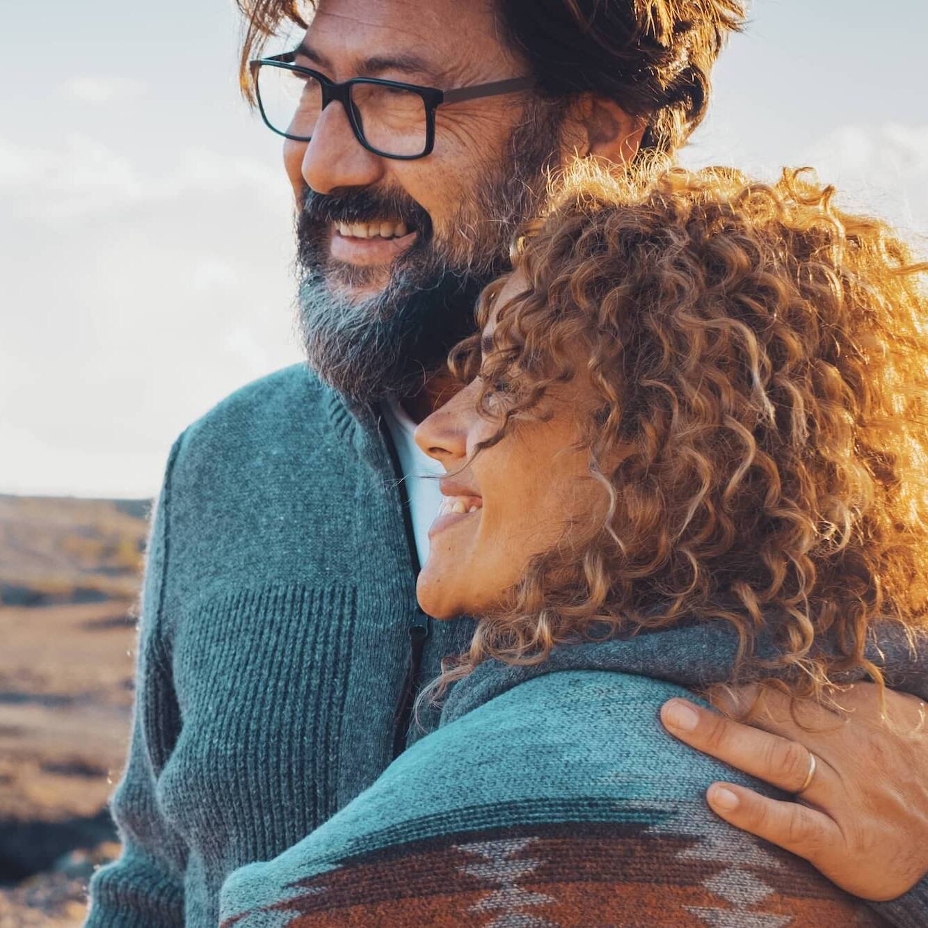 Smiling couple embracing while enjoying time outdoors together