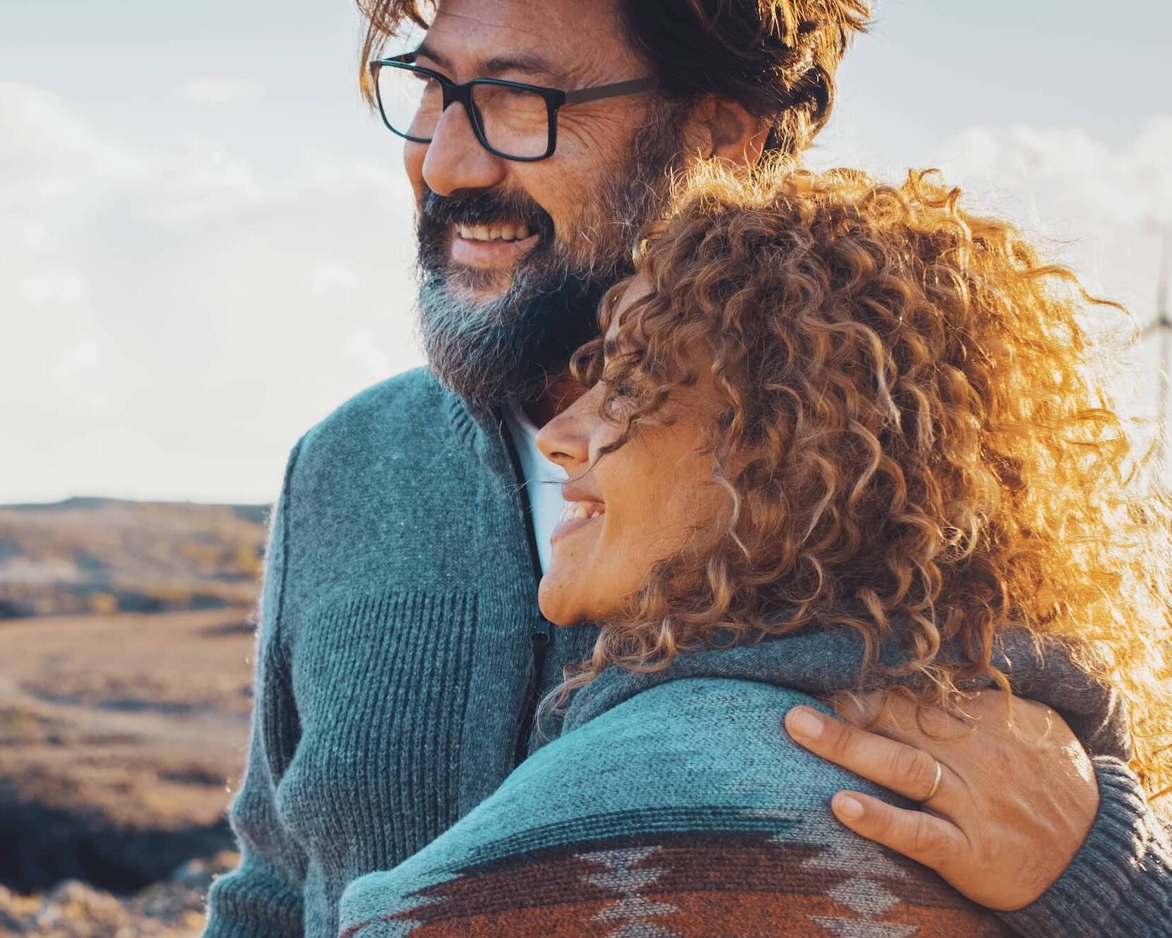 Smiling couple embracing while enjoying time outdoors together