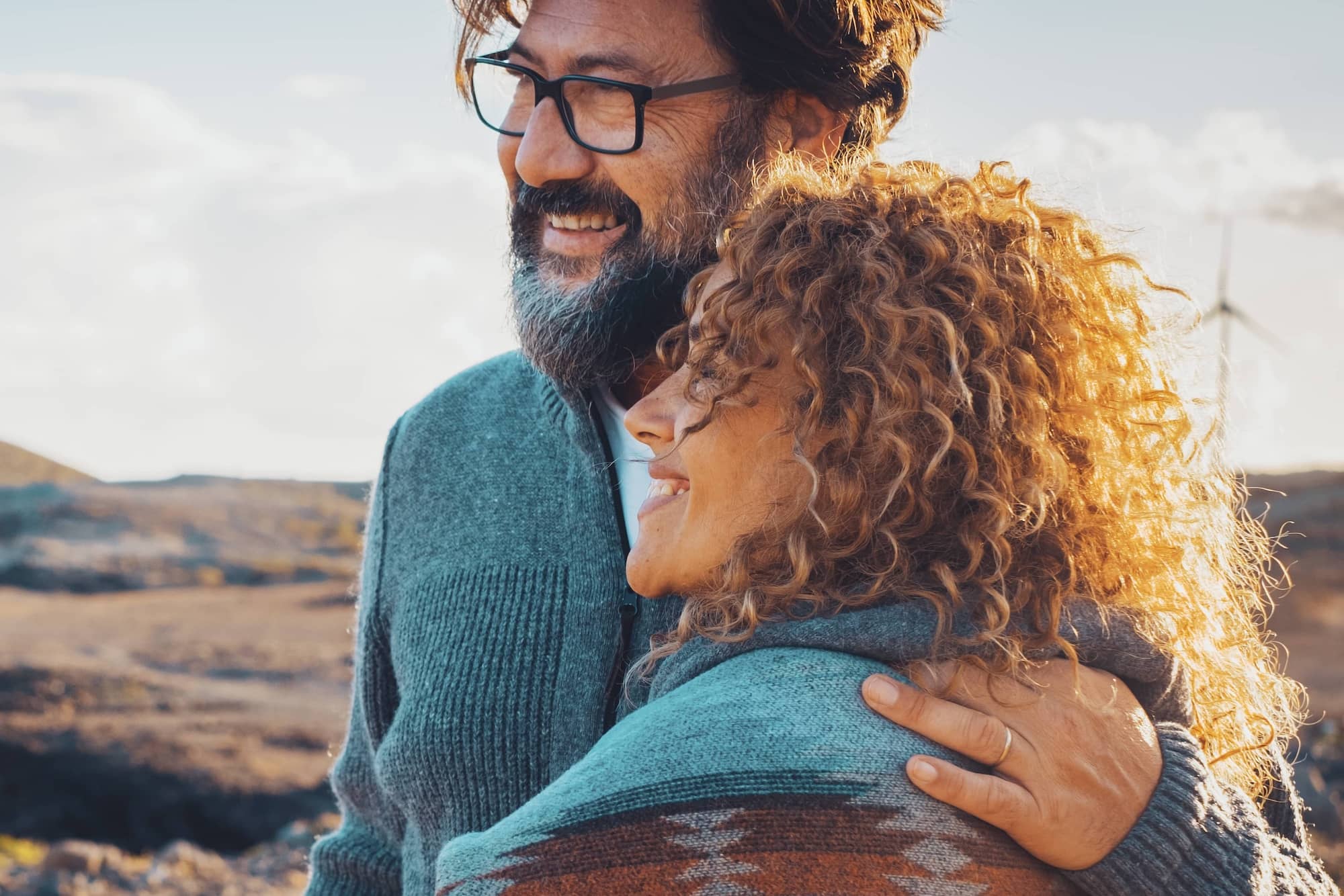 Smiling couple embracing while enjoying time outdoors together