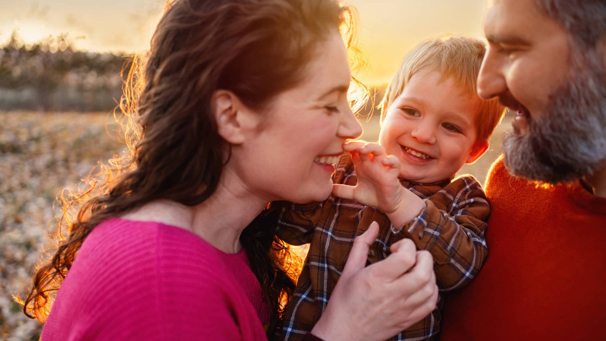 Parents enjoying time outdoors with their young child