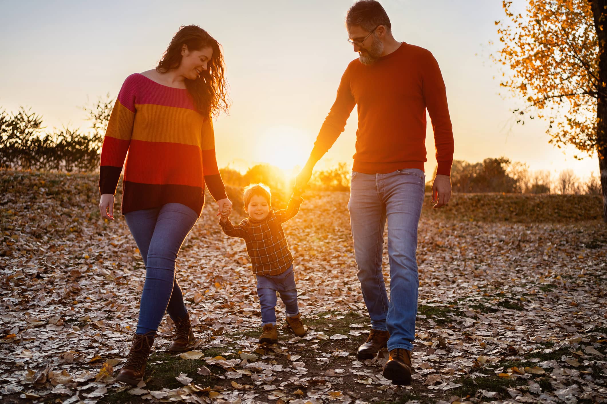 Parents walking outdoors with their young child